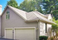 Large garage door showing surrounding vinyl siding.